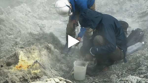 Collecting volcanic gas samples at a fumarole.